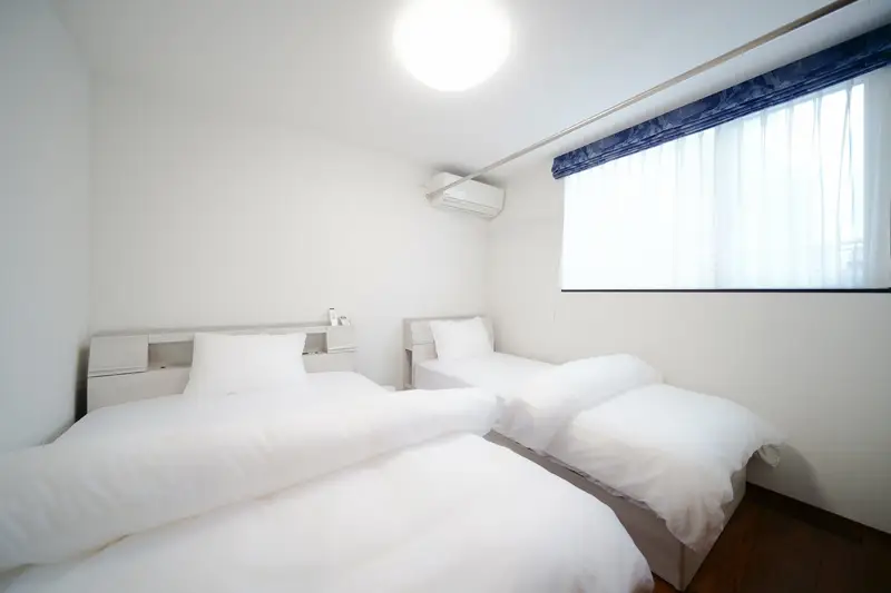 Beds, closet, and the bedroom window